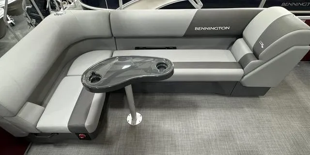 Slide: The Image of 2024 Bennington 20 SVL pontoon boat interior with gray seating and table. - 17