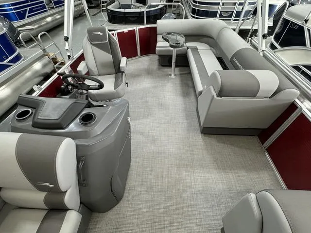Slide: The Image of 2024 Bennington 20 SVL pontoon boat interior with gray seating and steering console. - 18