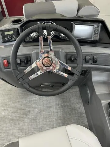 Slide: The Image of 2024 Bennington 20 SVL boat dashboard with steering wheel and control panel. - 20