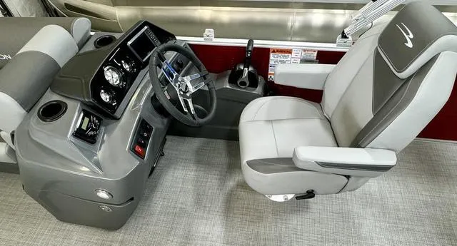 Slide: The Image of 2024 Bennington 20 SVL boat interior with steering console and captain's chair. - 21