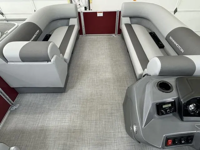 Slide: The Image of 2024 Bennington 20 SVL pontoon boat interior with gray seating and modern console. - 22