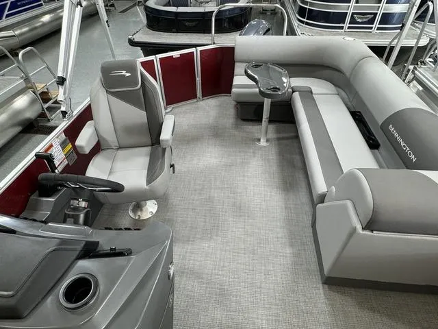 Slide: The Image of 2024 Bennington 20 SVL pontoon boat interior with gray seating and steering console. - 24