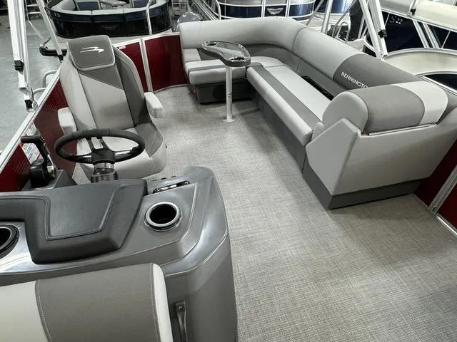 Slide: The Image of 2024 Bennington 20 SVL pontoon boat interior with gray seating and steering console. - 25