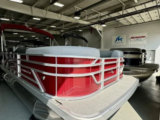 Slide: The Image of 2024 Bennington 20 SVL pontoon boat in showroom, red exterior, Munson Marine signage. - 3
