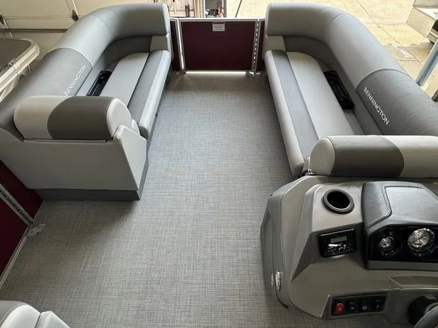 Slide: The Image of 2024 Bennington 20 SVL pontoon boat interior with gray seating and modern dashboard. - 7