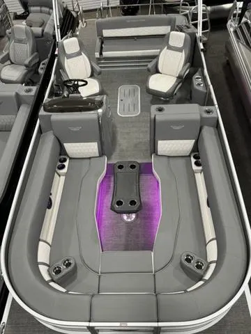 Slide: The Image of 2024 Bennington 25 LTSB pontoon boat with luxurious seating and ambient lighting. - 11