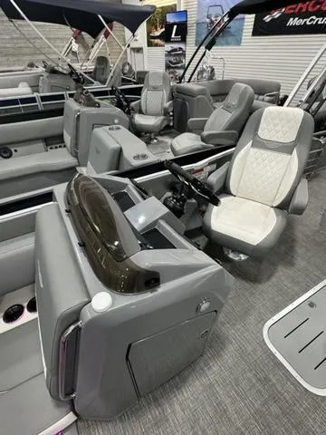 Slide: The Image of 2024 Bennington 25 LTSB pontoon boat interior with luxurious seating and modern helm. - 12