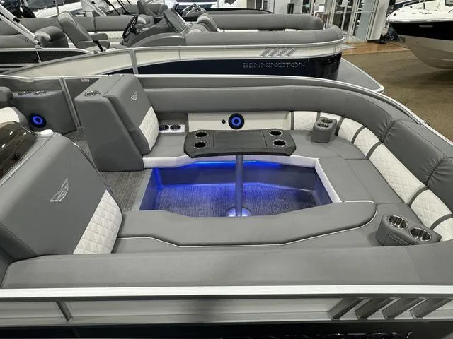 Slide: The Image of 2024 Bennington 25 LTSB pontoon boat interior with gray seating and blue LED lighting. - 20