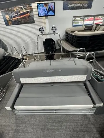 Slide: The Image of 2024 Bennington 25 LTSB pontoon boat with luxurious seating in showroom. - 21