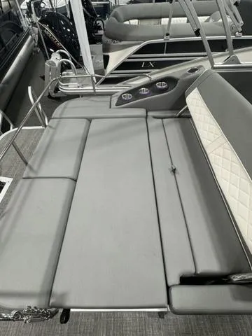 Slide: The Image of 2024 Bennington 25 LTSB boat interior with gray seating and quilted accents. - 22
