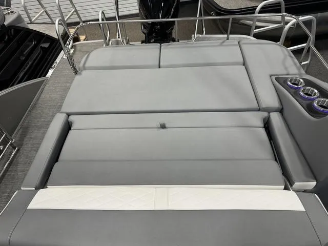 Slide: The Image of 2024 Bennington 25 LTSB boat with spacious gray seating and cup holders. - 23