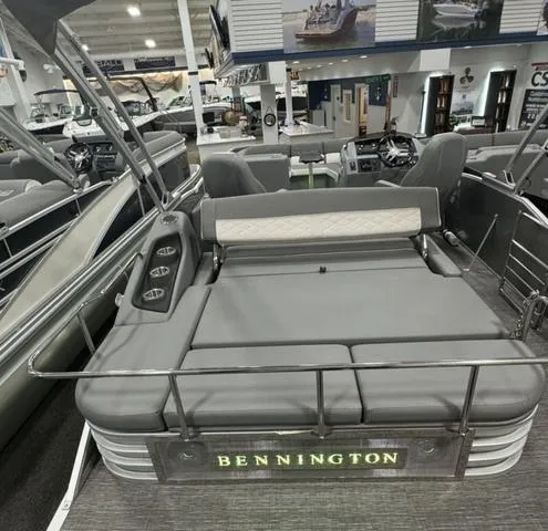 Slide: The Image of 2024 Bennington 25 LTSB pontoon boat with luxurious seating in showroom. - 29