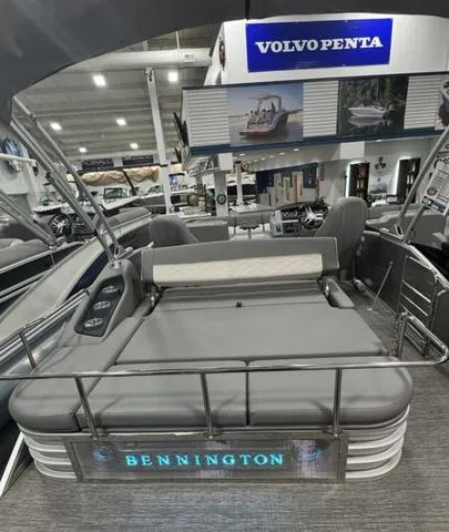 Slide: The Image of 2024 Bennington 25 LTSB pontoon boat displayed in showroom with Volvo Penta signage. - 30