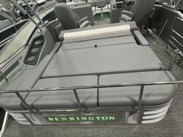 Slide: The Image of 2024 Bennington 25 LTSB boat interior with gray seating and cup holders. - 31