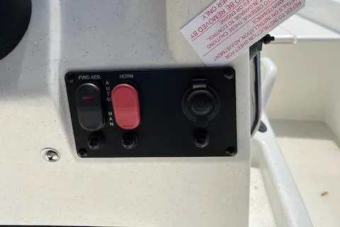 Slide: The Image of Control panel of a 2024 Mako Pro Skiff 15 CC boat with switches and labels. - 10