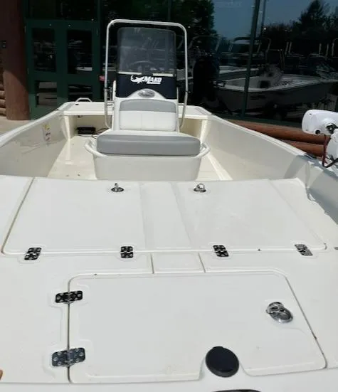 Slide: The Image of 2024 Mako Pro Skiff 15 CC boat interior with center console and seating. - 5