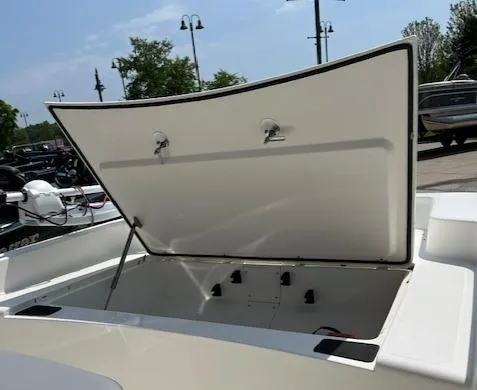 Slide: The Image of 2024 Mako Pro Skiff 15 CC with open storage compartment. - 7