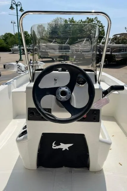 Slide: The Image of 2024 Mako Pro Skiff 15 CC center console with steering wheel. - 8