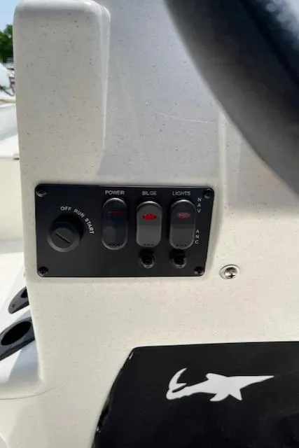 Slide: The Image of 2024 Mako Pro Skiff 15 CC control panel with power, bilge, and lights switches. - 9
