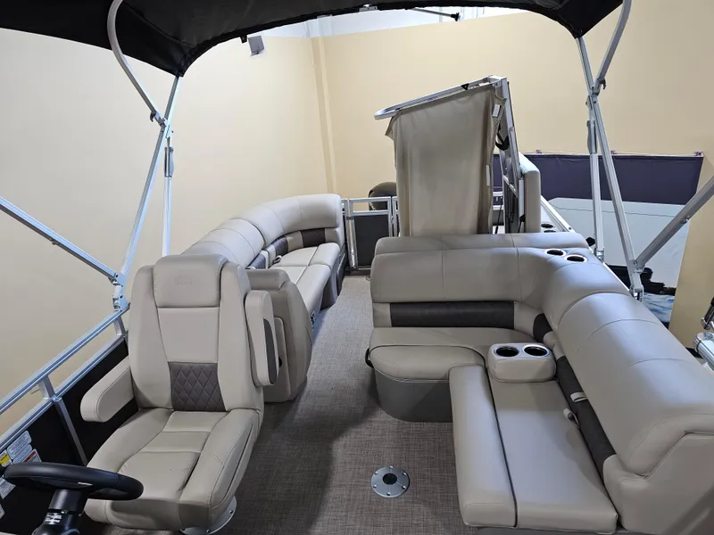 Slide: The Image of 2024 Sun Tracker Party Barge 22 RF XP3 interior with plush seating and cup holders. - 5