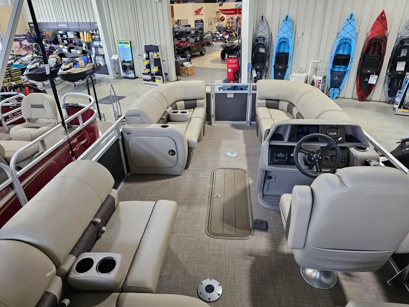 Slide: The Image of 2024 Sun Tracker Party Barge 22 RF XP3 interior with plush seating and modern dashboard. - 7