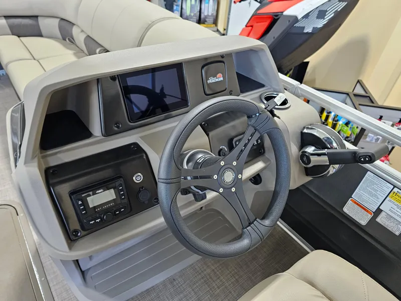 Slide: The Image of 2024 Sun Tracker Party Barge 22 RF XP3 dashboard with steering wheel and controls. - 8