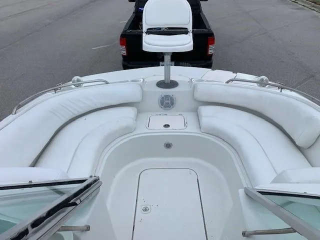 Slide: The Image of 2004 Hurricane 187SD boat with white seating and a fishing chair. - 11