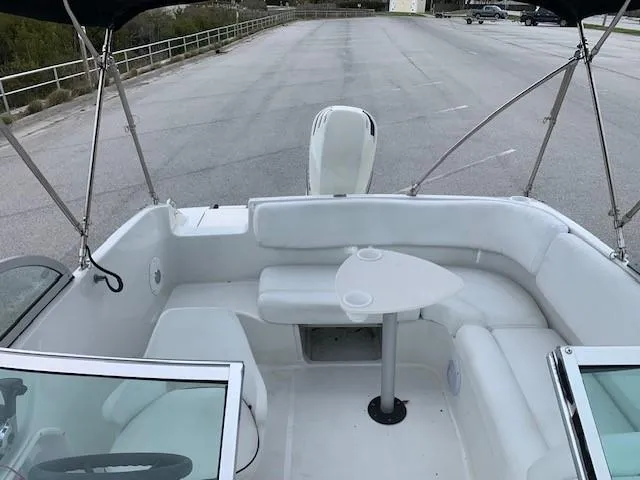 Slide: The Image of 2004 Hurricane 187SD boat interior with white seating and table. - 15