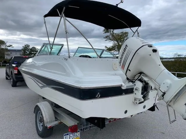 Slide: The Image of 2004 Hurricane 187SD boat with Johnson Evinrude J150BXSR outboard motor on trailer. - 3
