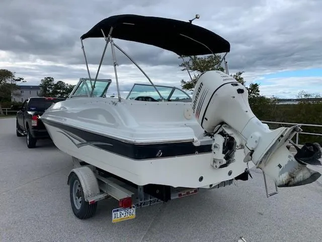 Slide: The Image of 2004 Hurricane 187SD boat on trailer with outboard motor. - 8
