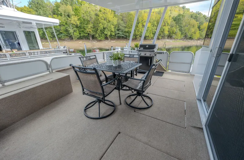 Slide: The Image of Spacious deck on 2007 Fantasy 19 X 90 houseboat with outdoor dining set and grill. - 15