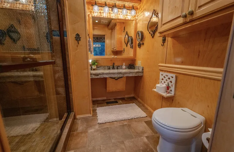 Slide: The Image of Cozy wooden bathroom with modern fixtures, glass shower, and elegant lighting, Fantasy 19 X 90, 2007. - 27