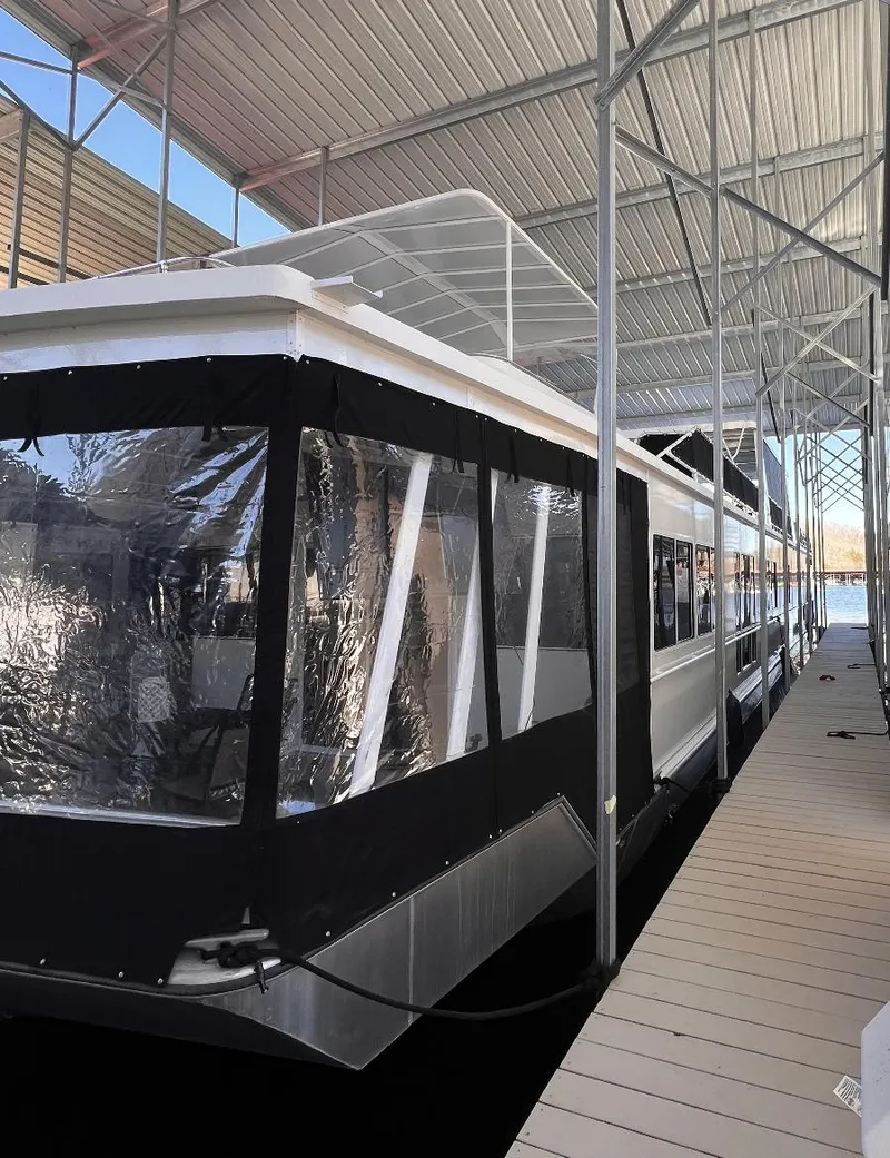 Slide: The Image of 2007 Fantasy 19 X 90 houseboat docked under a covered marina. - 3