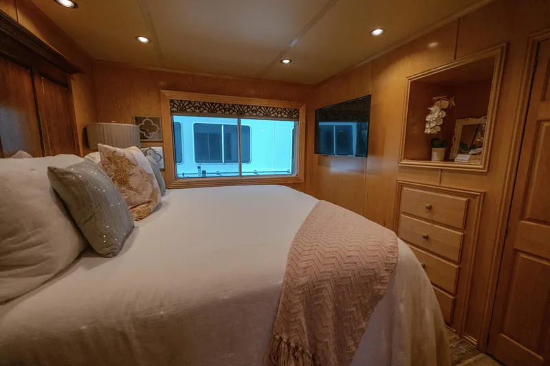Slide: The Image of Cozy bedroom in 2007 Fantasy 19 X 90 houseboat with elegant decor and large window. - 31