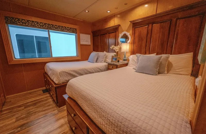 Slide: The Image of Cozy bedroom with twin beds, wooden decor, and soft lighting in a Fantasy 19 X 90 model. - 33