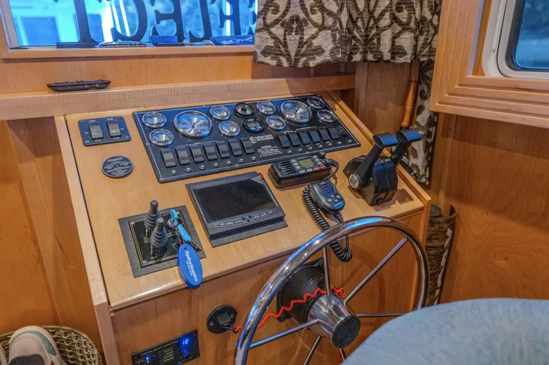 Slide: The Image of Control panel of a 2007 Fantasy 19 X 90 boat with steering wheel and gauges. - 37