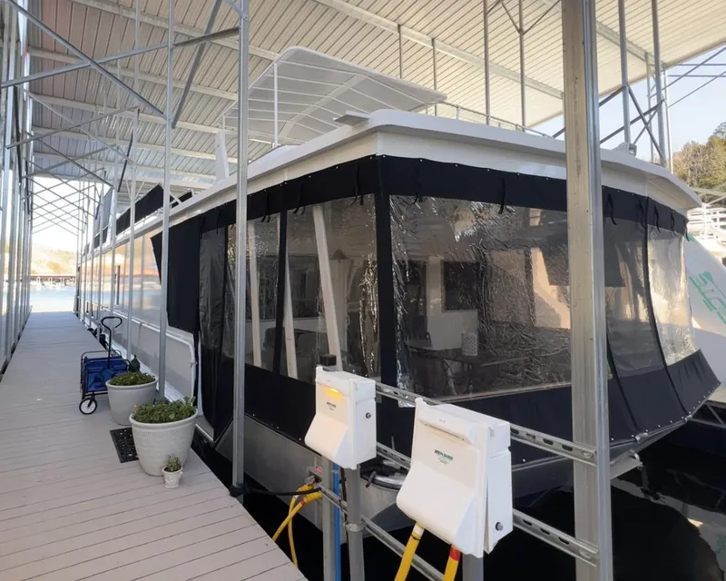 Slide: The Image of 2007 Fantasy 19 X 90 houseboat docked under a covered marina. - 6