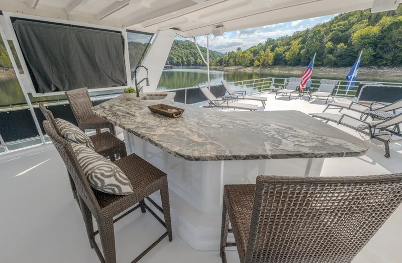Slide: The Image of Luxury yacht deck with bar, wicker chairs, and scenic lake view. Fantasy 19 X 90, 2007 model. - 8