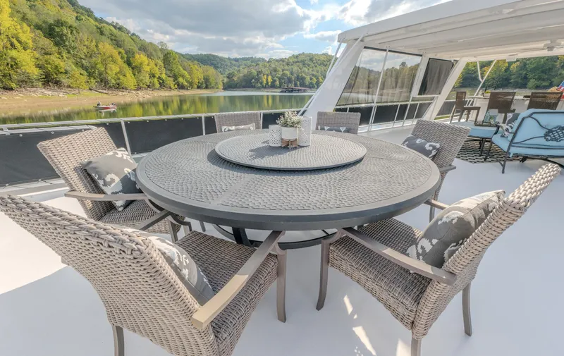 Slide: The Image of Outdoor dining set on a Fantasy 19 X 90 houseboat, surrounded by scenic lake views. - 9