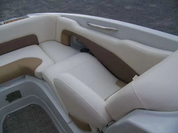 Slide: The Image of 2016 Crownline E4 boat interior with beige and brown cushioned seating. - 11