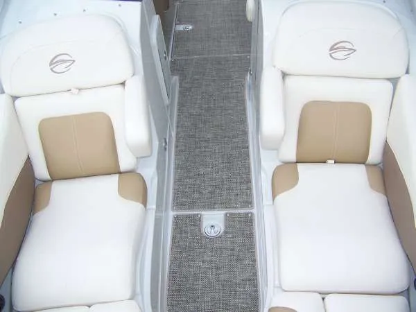 Slide: The Image of 2016 Crownline E4 boat interior with beige and white seating, gray carpeted floor. - 13
