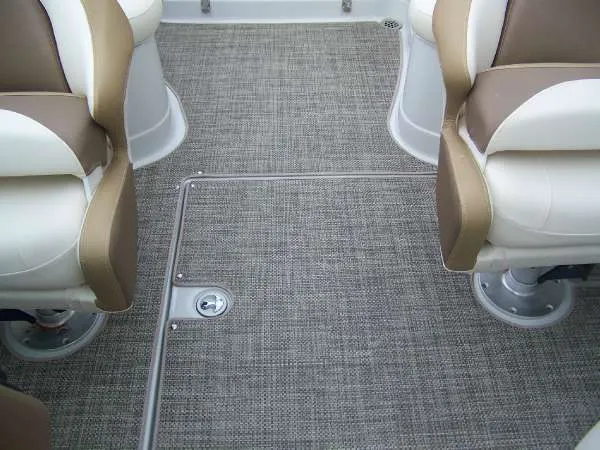 Slide: The Image of 2016 Crownline E4 boat interior with beige and white seating and textured flooring. - 17