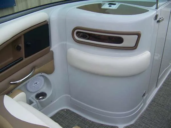 Slide: The Image of Interior of a 2016 Crownline E4 boat, featuring beige and white seating with speaker detail. - 19