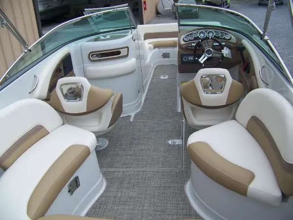 Slide: The Image of 2016 Crownline E4 boat interior with beige and white seating, sleek dashboard, and modern design. - 8