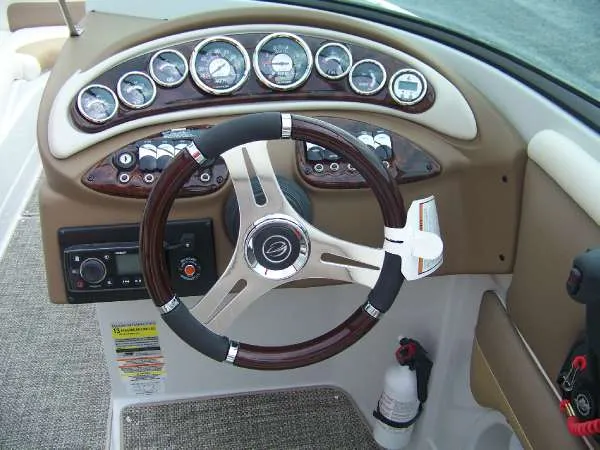 Slide: The Image of 2016 Crownline E4 boat dashboard with steering wheel and instrument panel. - 9