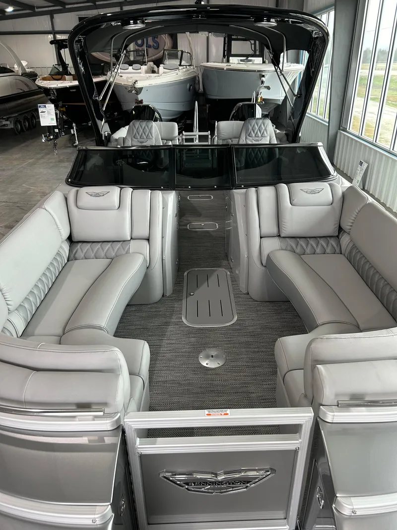 Slide: The Image of 2024 Bennington 27 QFBA luxury pontoon boat interior with plush seating. - 11