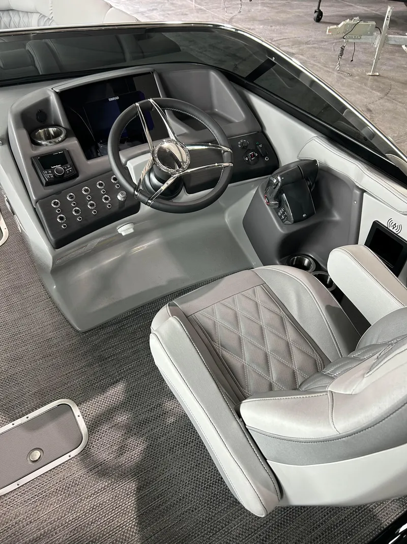 Slide: The Image of 2024 Bennington 27 QFBA boat cockpit with modern steering wheel and control panel. - 7