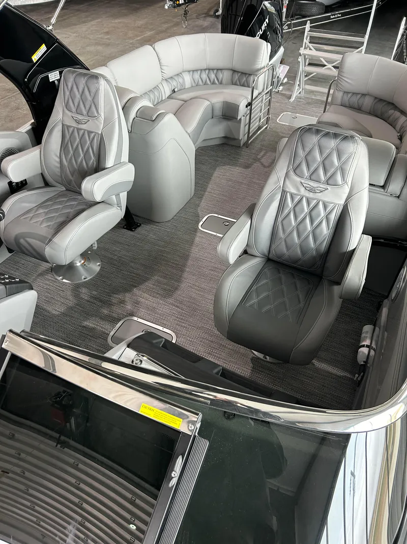 Slide: The Image of 2024 Bennington 27 QFBA luxury pontoon boat interior with plush seating. - 9