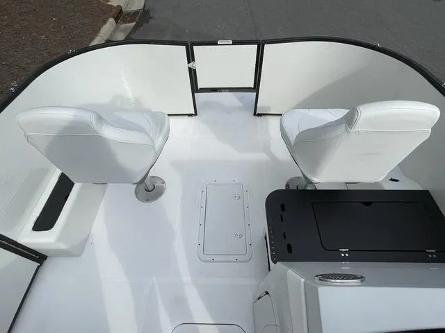 Slide: The Image of 2023 Hurricane FunDeck 1960 REF OB boat interior with white seating and storage compartments. - 7
