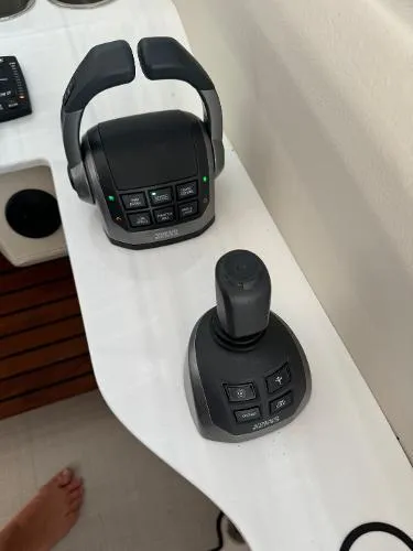 Slide: The Image of 2023 Regal LS36 boat controls with joystick and throttle on white surface. - 10